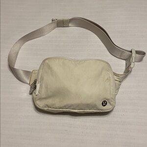 Lululemon Everywhere Belt Bag 1L in the color White Opal Zip for closing